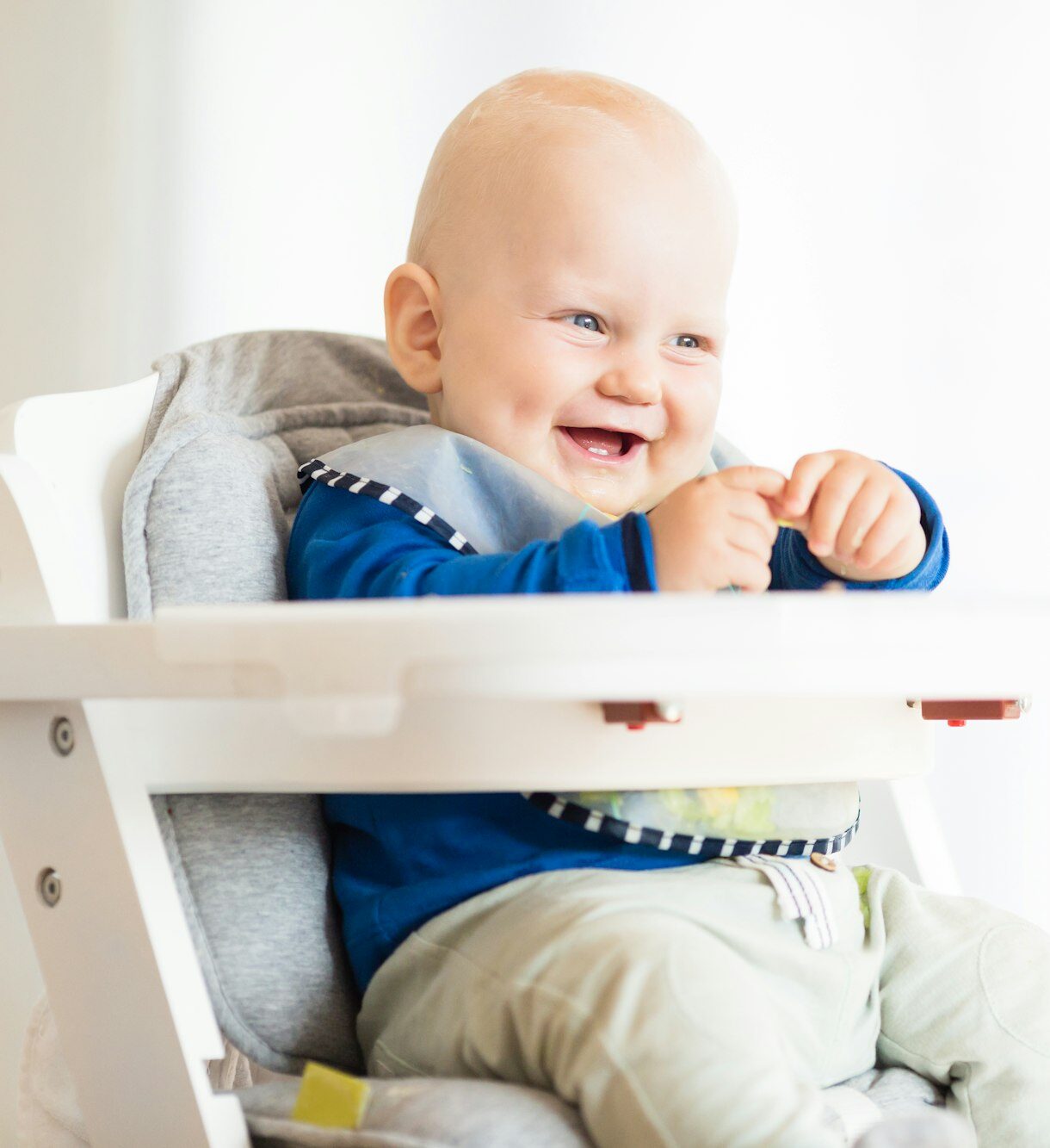 Baby boy eating with BLW method, baby led weaning